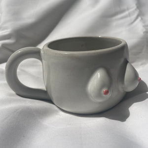 A white BoobyPot mug with pink nipples.