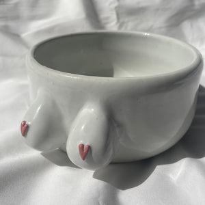 White BoobyPot planter with pink heart shaped nipples.