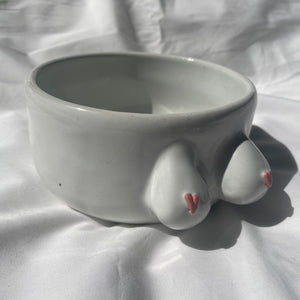 White BoobyPot planter with pink heart shaped nipples.
